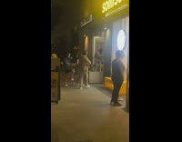 Three people dance outside ice cream store