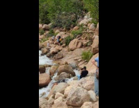 Man tracksuit rap video shoot at waterfalls