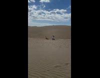 Girl bikini lay sand dunes raise legs