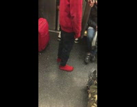 Spiderman in red jacket glued shoes rides subway train 
