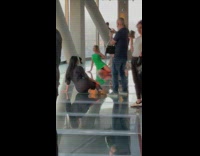 Woman green dress sit pose glass floor