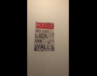 Woman shows poster hung on toilet pubs