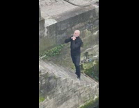 Man bald in black turtle neck sweater river park