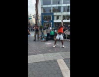 People dance with live band on street