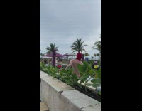 Man with a Deadpool mask swims at the pool