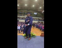Guy in blue graduation gown hits the woah on stage