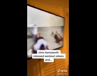 Girl watches Chris Hemsworth workout videos bed