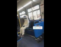guy dressed as yeti waves sitting on bus