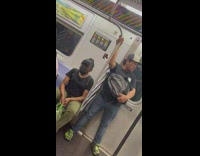 Man pink jacket eat chips inside train