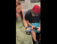 Woman hold phone while man play with controller