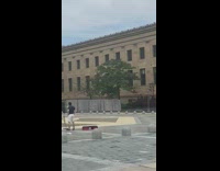 Red shirt lady lifts weights during protest 