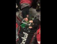 Man picks up turtles inside container on subway train