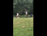 White shirt guy bicycle basketball on head 