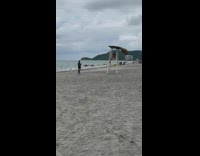 Woman in bikini sits on the lifeguard post