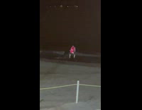 Woman in red bikini twerks at the beach nighttime