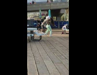 Two women dance pier green pants bridge
