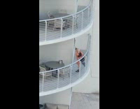 Collab IITW - Woman poses on the building balcony railings