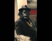 Guy dressed in gorilla tuxedo suit dances in subway station