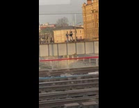 Guy black jacket dance   metal frame railway 