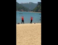 Two girls crab costume dance video beach
