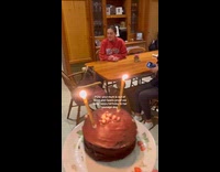 Dog with hat celebrates birthday with cake