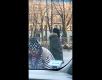 Clown juggles in front of cars