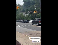 Guy bounces down street riding tall stilts
