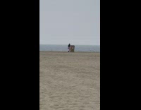 Woman in violet skirt tiktok dance beach trash bin