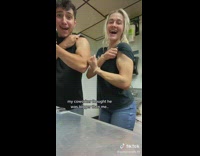 Woman and coworker compares and flex muscles