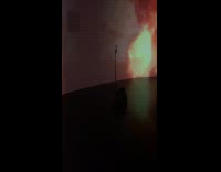 Woman striped sweater films inside art exhibit