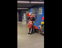 Man carries skeleton partner at train station