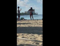 Woman in mickey mouse oversized shirt tiktok on beach