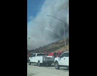 California wildfire thick and black smoke in the air