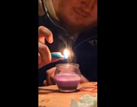 Man lights up candle lighter over glass