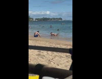 Woman in bikini poses and lie down on the beach shore