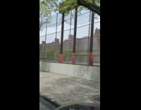 Firefighter waters closed park grass fire hose 