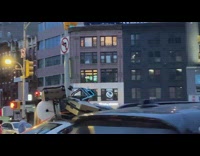 White car lots of stuff on roof stoplight