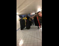 People dressed in medieval clothing walk through subway station