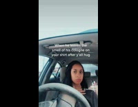 Girl in car smells shirts 