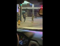 Woman green themed outfit video shoot sidewalk night time