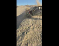 Off road vehicle stuck splash up sand 