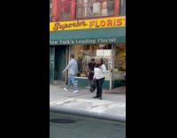 Man spray paint flowers at flower shop