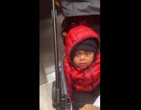 Toddler laughs at filmer sings in elevator