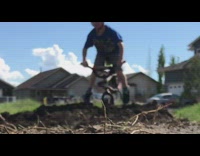 Little boy rides bike off dirt ramp and face plants into the ground
