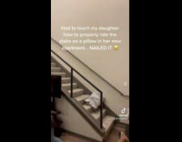 Mom slides down stairs on pillow