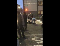 blonde man black jacket on floor of street 