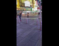 Woman orange jacket face mask times square