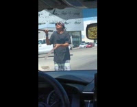 Guy does machete tricks in middle road