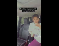 Girl pranks sister with sour pickle ball candy 