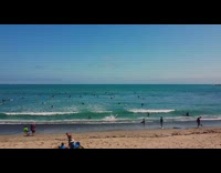 Guy running with surfboard trips and falls